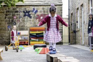 Child walking on balance area outside